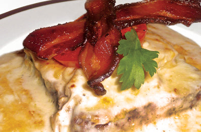 Texas Pete® Hot Brown Featuring Roasted Tomato, Bacon, & Mornay Sauce Atop Cheddar & Chive Biscuits